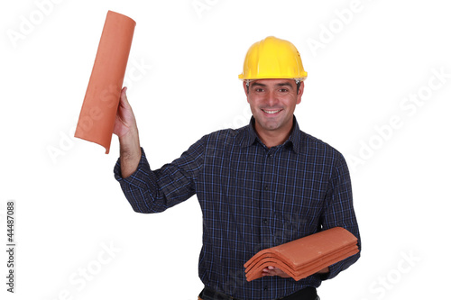 Photo: Builder holding roof tiles Builder holding roof tiles