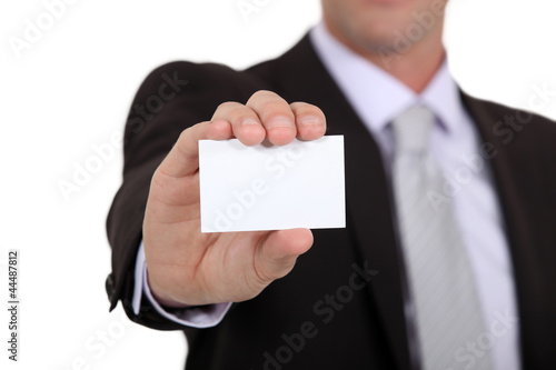 Photo: successful businessman holding business card successful businessman holding business card
