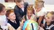 Video: Happy schoolchildren searching country on the globe Happy schoolchildren searching country on the globe