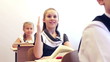 Adorable smart schoolgirl raising hand and giving answer