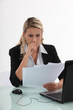 Businesswoman reviewing paperwork