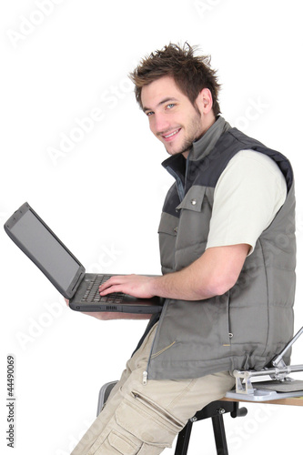 Photo: Tiles sat on work-bench with laptop Tiles sat on work-bench with laptop
