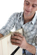 Furniture maker sanding wood