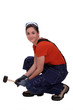 Woman with mallet crouching