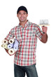 portrait of do-it-yourselfer carrying wallpaper rolls and brush