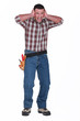 Builder with his hands over his ears