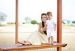 Photo: The little boy with mother on walk at the sea The little boy with mother on walk at the sea