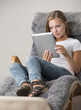 Young adult female reading on a tablet pc