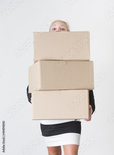 Photo: Woman carrying carboard boxes Woman carrying carboard boxes