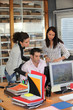 Photo: Group of office workers looking at a computer Group of office workers looking at a computer