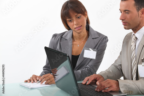 Photo: Young business professionals working on a project together Young business professionals working on a project together