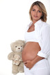 Pregnant woman with teddy bear