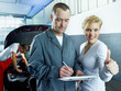 Female customer shows thumb up for good service in a garage