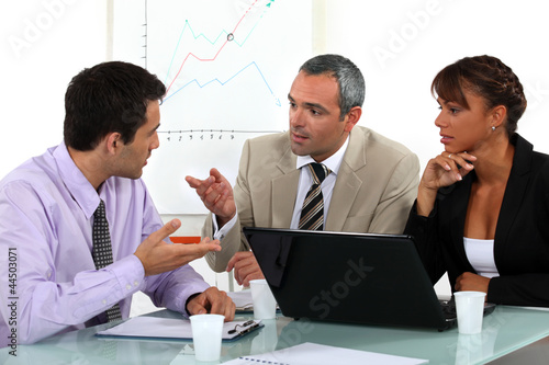 Photo: A businessteam working on a project. A businessteam working on a project.