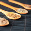 various spices in wooden spoons