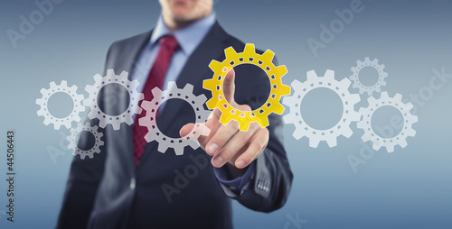 Foto: Man with interface and cogwheels Man with interface and cogwheels
