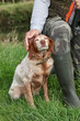 man hunting and caressing his dog