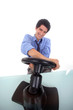 Man steering a wheel in his office.