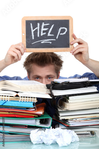 Photo: Student swamped under paperwork Student swamped under paperwork