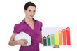 craftswoman holding energy consumption chart