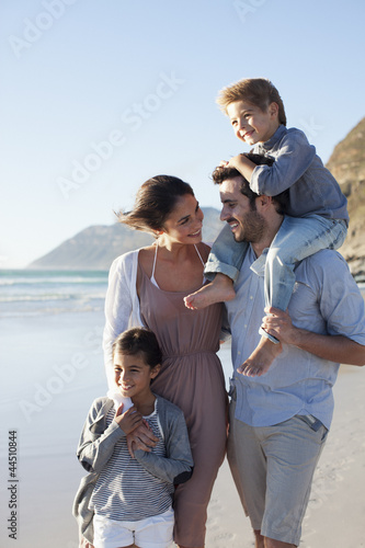 Photo: Smiling family on sunny beach Smiling family on sunny beach