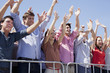 Cheering crowd with arms raised