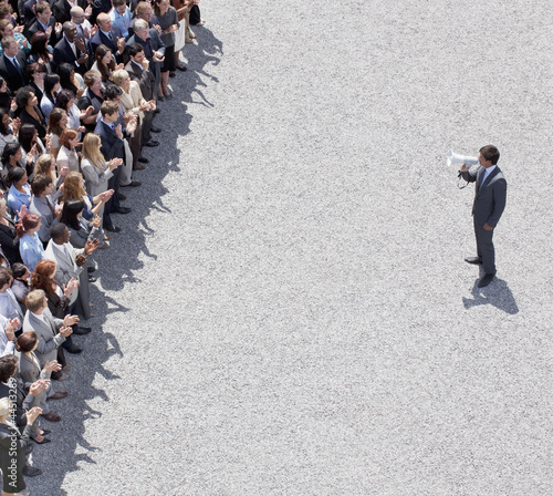 Photo: Businessman with bullhorn talking to crowd of people Businessman with bullhorn talking to crowd of people