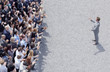 Businessman addressing clapping crowd