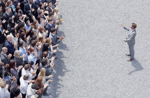 Photo: Businessman addressing clapping crowd Businessman addressing clapping crowd