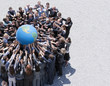 Crowd of business people in huddle reaching for globe