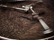 Foto: Coffee beans being processed in roasting machine Coffee beans being processed in roasting machine