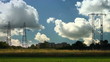 Video: Electrical towers on cloudy sky, near some houses Electrical towers on cloudy sky, near some houses