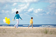 Photo: Mother and little son with ballons on the beach Mother and little son with ballons on the beach