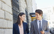 Businessman and businesswoman walking in city