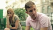 Relationship difficulties, couple sitting in city