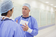 Surgeons talking in hospital corridor