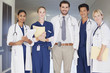 Portrait of smiling doctors and nurse in hospital corridor