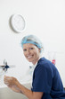 Portrait of smiling nurse washing hands