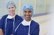 Portrait of smiling nurses in hospital corridor