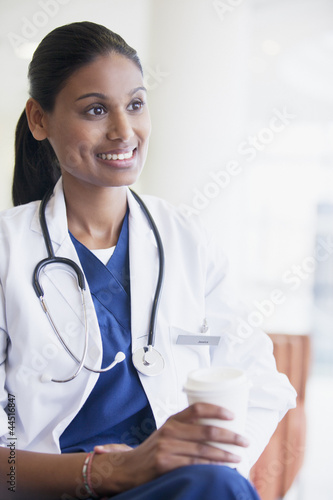 Photo: Smiling doctor drinking coffee Smiling doctor drinking coffee