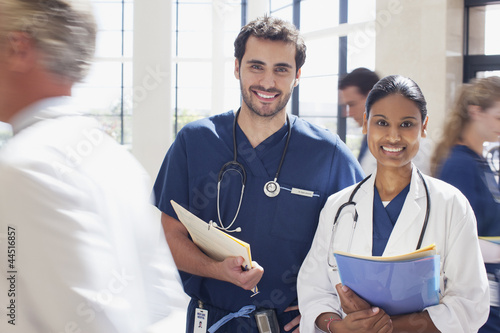 Photo: Portrait of smiling doctor and nurse in hospital Portrait of smiling doctor and nurse in hospital