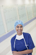 Portrait of smiling nurse in hospital corridor