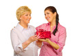 Senior woman giving gift to her daughter