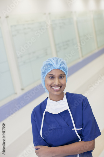 Photo: Portrait of smiling nurse in hospital corridor Portrait of smiling nurse in hospital corridor