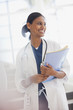 Smiling doctor holding medical records