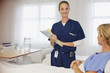 Portrait of smiling nurse with patient in hospital room