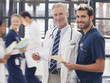 Portrait of smiling doctor and nurse in hospital