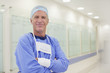 Portrait of smiling surgeon in hospital corridor