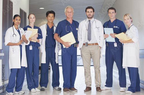 Photo: Portrait of confident doctors and nurses in hospital corridor Portrait of confident doctors and nurses in hospital corridor