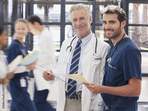 Photo: Portrait of smiling doctor and nurse in hospital Portrait of smiling doctor and nurse in hospital